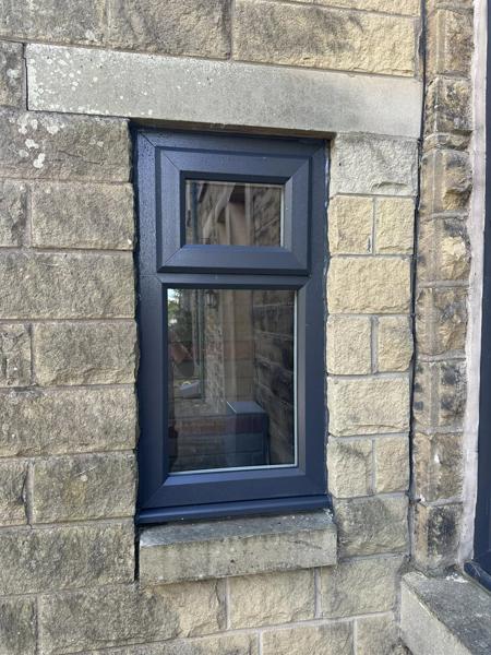 Navy top-hung window on a stone house